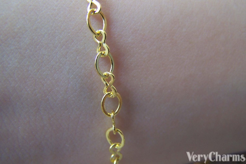 May include: A gold chain necklace with a delicate, oval-shaped link design.