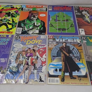 May include: A collection of eight comic books featuring various superheroes and characters. The comics include Green Lantern, Hawk and Dove, Detective Comics, Viper, and others. The covers are colorful and feature action-packed scenes.