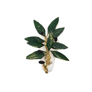 May include: A handcrafted olive branch brooch. The brooch features dark green leaves with gold accents and black olive-shaped beads. The leaves and olives are attached to a white stone with gold wire.