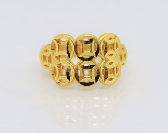 May include: A gold ring with a design of multiple interlocking circles. The circles have a square pattern inside.