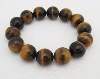 May include: A brown and gold tiger's eye beaded bracelet with 14 round beads.