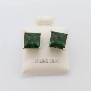 May include: A pair of sterling silver earrings with square green gemstones.
