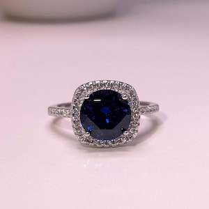 Vintage Sterling Silver Blue Sapphire & White Topaz Halo Ring.