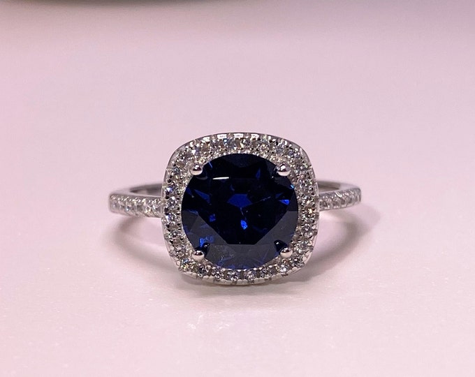 Vintage Sterling Silver Blue Sapphire & White Topaz Halo Ring.