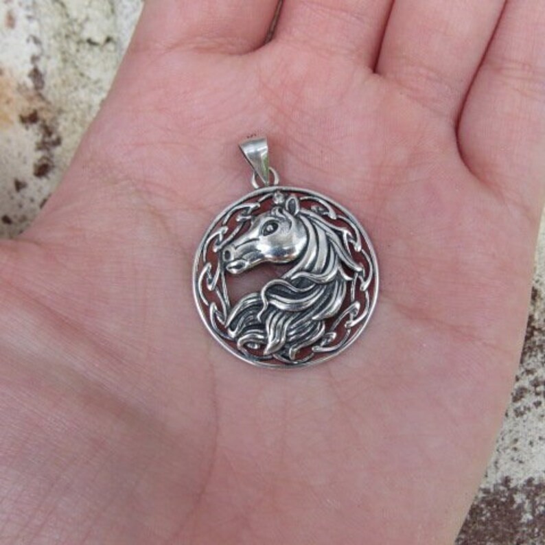 May include: Silver pendant featuring a detailed horse head design within a circular Celtic knot border.