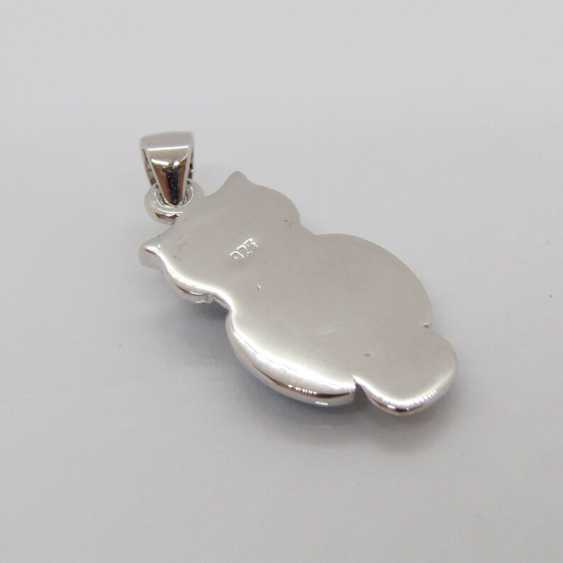 May include: Silver owl pendant with a 925 stamp on the back.