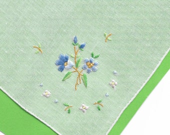 1 handkerchief was hand embroidered with this flower 100% cotton organic  was hand-rolled