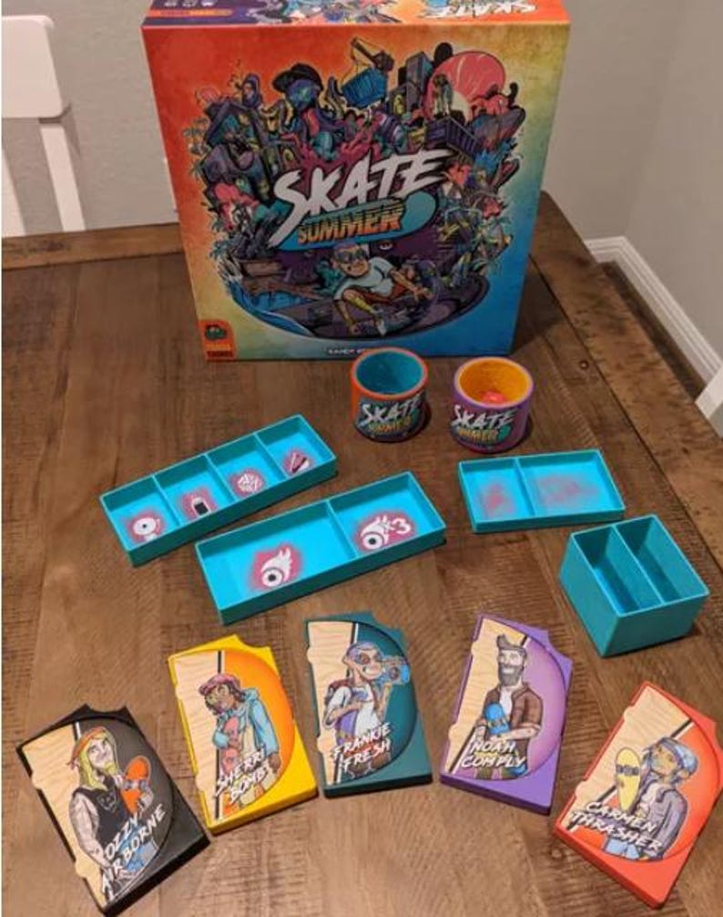 May include: A board game called "Skate Summer" with colorful illustrations of skateboarders and a city scene. The game includes a game board, cards, tokens, and dice. The game is designed for ages 8 and up.