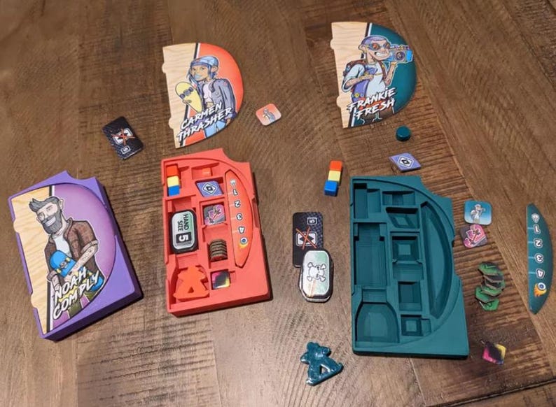 May include: A game with colorful wooden character cards, a red and orange storage tray, and a green and blue storage tray. The character cards feature illustrations of people skateboarding and the text "Carmen Thrasher", "Frankie Fresh", and "Noah Comply".