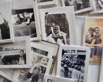 May include: A collection of vintage black and white photographs in various sizes and frames. The photos depict people, landscapes, and events from the past.