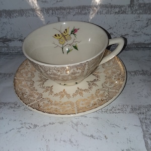 Butterfly and gold cup and saucer