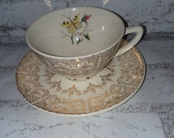 Butterfly and gold cup and saucer