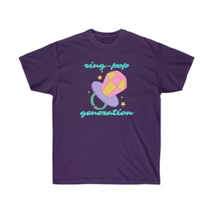 May include: Purple t-shirt with a graphic of a pink and yellow ring pop with the text "ring-pop generation" in turquoise.