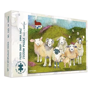 May include: A jigsaw puzzle box featuring a colorful illustration of a flock of sheep on a green hillside with a small house. The puzzle is labeled "Felted Sheep" and is 69cm x 48cm in size, with 1000 pieces. The box has the text "Made in the UK".