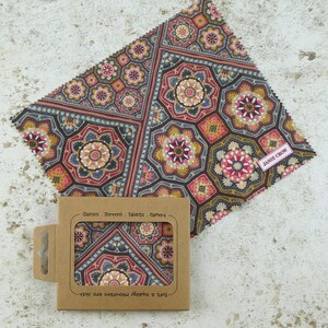 May include: A brown and gray microfiber cleaning cloth with a geometric pattern. The cloth is packaged in a brown cardboard box with the text "Soft & Absorbent Microfiber Cloth" and "Glasses, Screens, Tablets, Camera" printed on it. The cloth is labeled "Janie Crow".