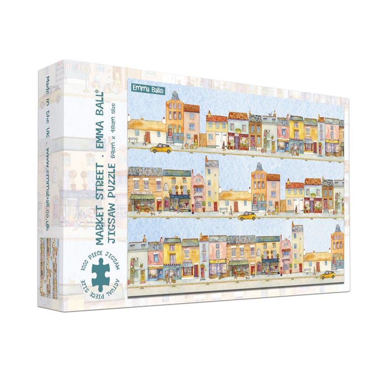 May include: A 1000-piece jigsaw puzzle featuring a watercolor illustration of a street scene with colorful buildings and yellow cars. The puzzle is labeled "Market Street" by Emma Ball, with an actual size of 27 x 19 inches.