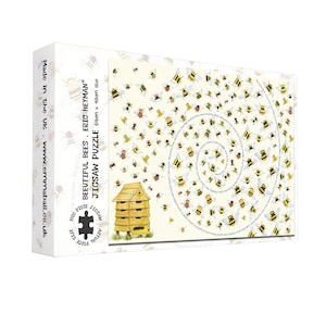 May include: A jigsaw puzzle box featuring a whimsical design of bees in flight, with a spiral pattern and a wooden beehive illustration. The puzzle is labeled "BEAUTIFUL BEES" and is 69cm x 48cm in size.