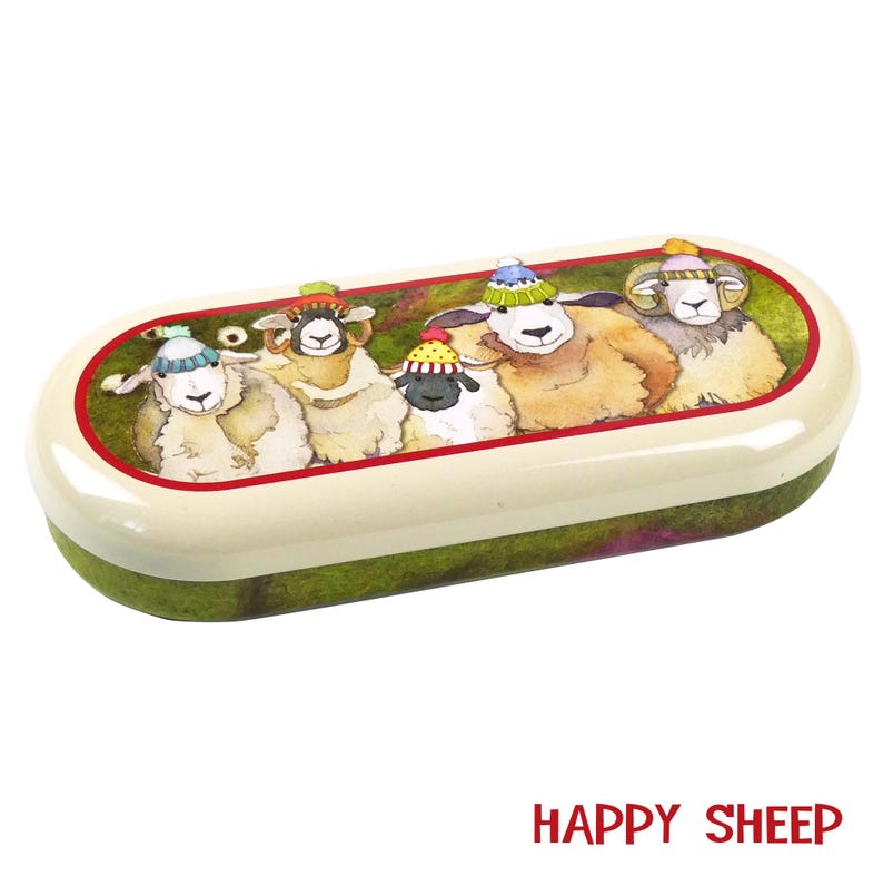 May include: A white oval-shaped glasses case with a green and brown background. The case features a colorful illustration of five sheep wearing knitted hats. The text "HAPPY SHEEP" is printed in red at the bottom of the image.