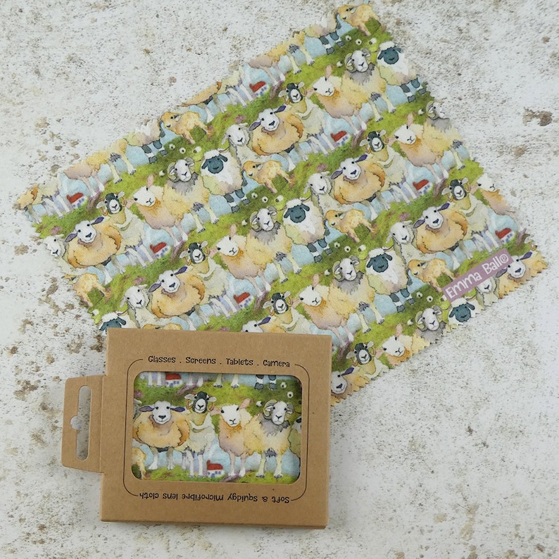 May include: A brown cardboard box with a white and green microfiber cleaning cloth inside. The cloth has a repeating pattern of sheep and houses. The box has the text "Soft & Springy Microfibre Cloth" and "Glasses - Screens - Tablets - Camera" printed on it.