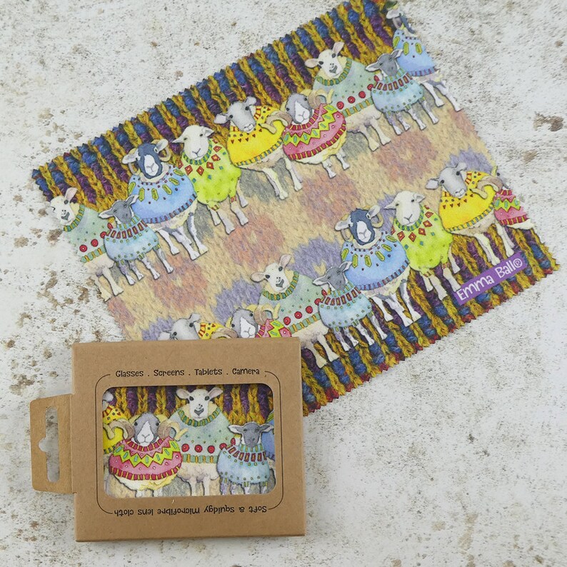 May include: A pack of microfiber cleaning cloths featuring a colorful illustration of sheep wearing sweaters. The cloths are designed for cleaning glasses, screens, tablets, and cameras. The packaging includes the text "Safe for all smartphone screens & tablets".
