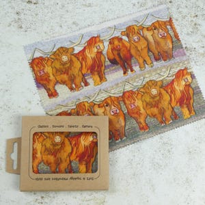 May include: A set of 8 microfiber cloths with a watercolor illustration of Highland cows. The cloths are packaged in a brown cardboard box with the text "Set of 8 Aprons & Microfibre Lens Cloth Glasses - Screens - Tablets - Camera" printed on the front.