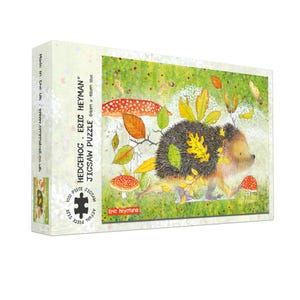 May include: A jigsaw puzzle box featuring a whimsical illustration of a hedgehog with autumn leaves and mushrooms. The box reads "HEDGEHOG - ERIC HEYMAN JIGSAW PUZZLE" and indicates a 69cm x 48cm size. The puzzle contains 1000 pieces.