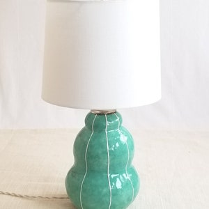 Handmade jade green ceramic lamp with white linen shade