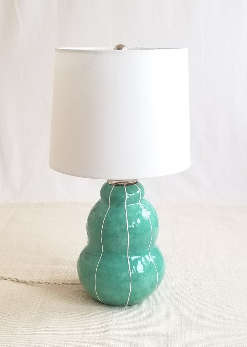 Handmade jade green ceramic lamp with white linen shade