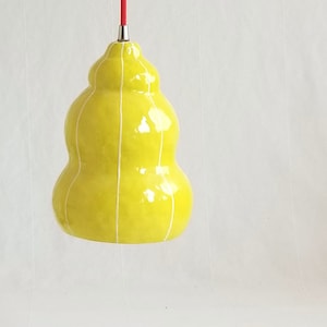 Handmade, organic form pendant light in chartreuse with thin white stripes