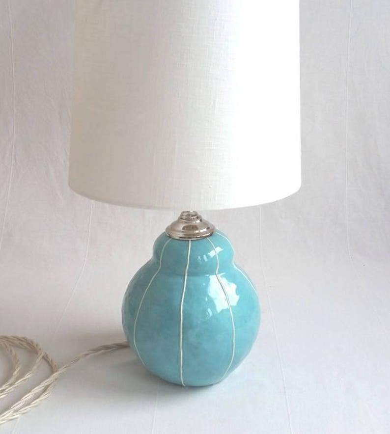Handmade light turquoise ceramic table lamp with white stripes and white shade