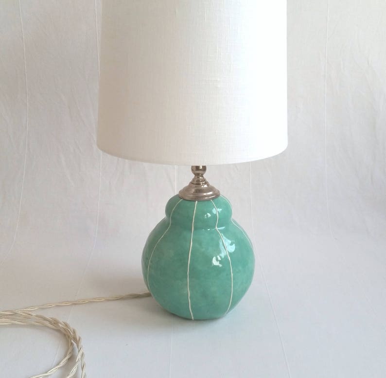 Handmade jade green ceramic table lamp with white stripes and white shade