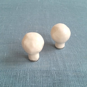 Pair of lamp finials. Simple white or metallic black. Decorative lampshade hardware