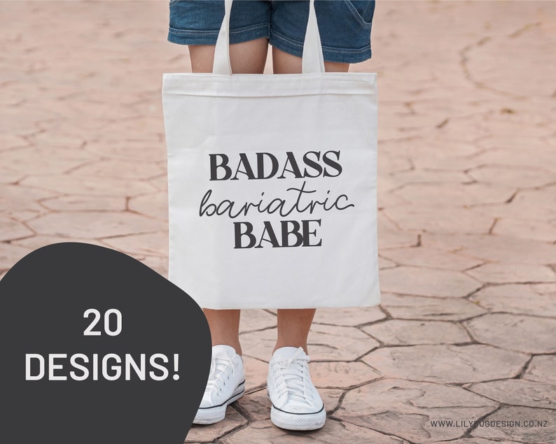 May include: A white tote bag with the text "BADASS bariatric BABE" printed in black. The bag is being held by a person wearing jeans and white sneakers.