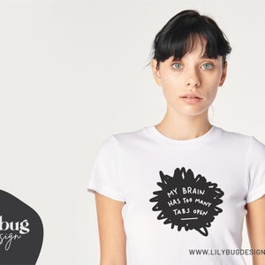 May include: White t-shirt with a black graphic that says "My brain has too many tabs open".