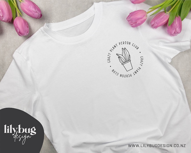 May include: White t-shirt with a black graphic design that says "Crazy Plant Person Club" with a plant in a pot in the center.