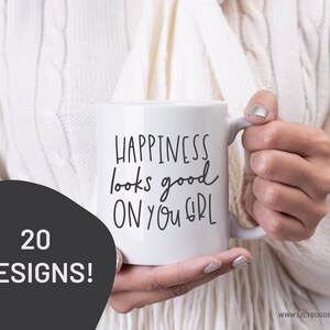 May include: White ceramic mug with black handwritten text that reads "Happiness looks good on you girl".