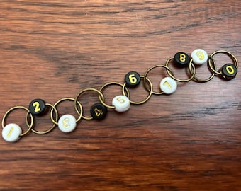 Row Counting Stitch Marker: Black and White Beads, Gold Numbers, Antique Bronze Rings