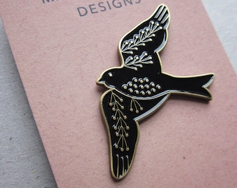 Bird enamel pin brooch, black and gold metal, swallow folk design