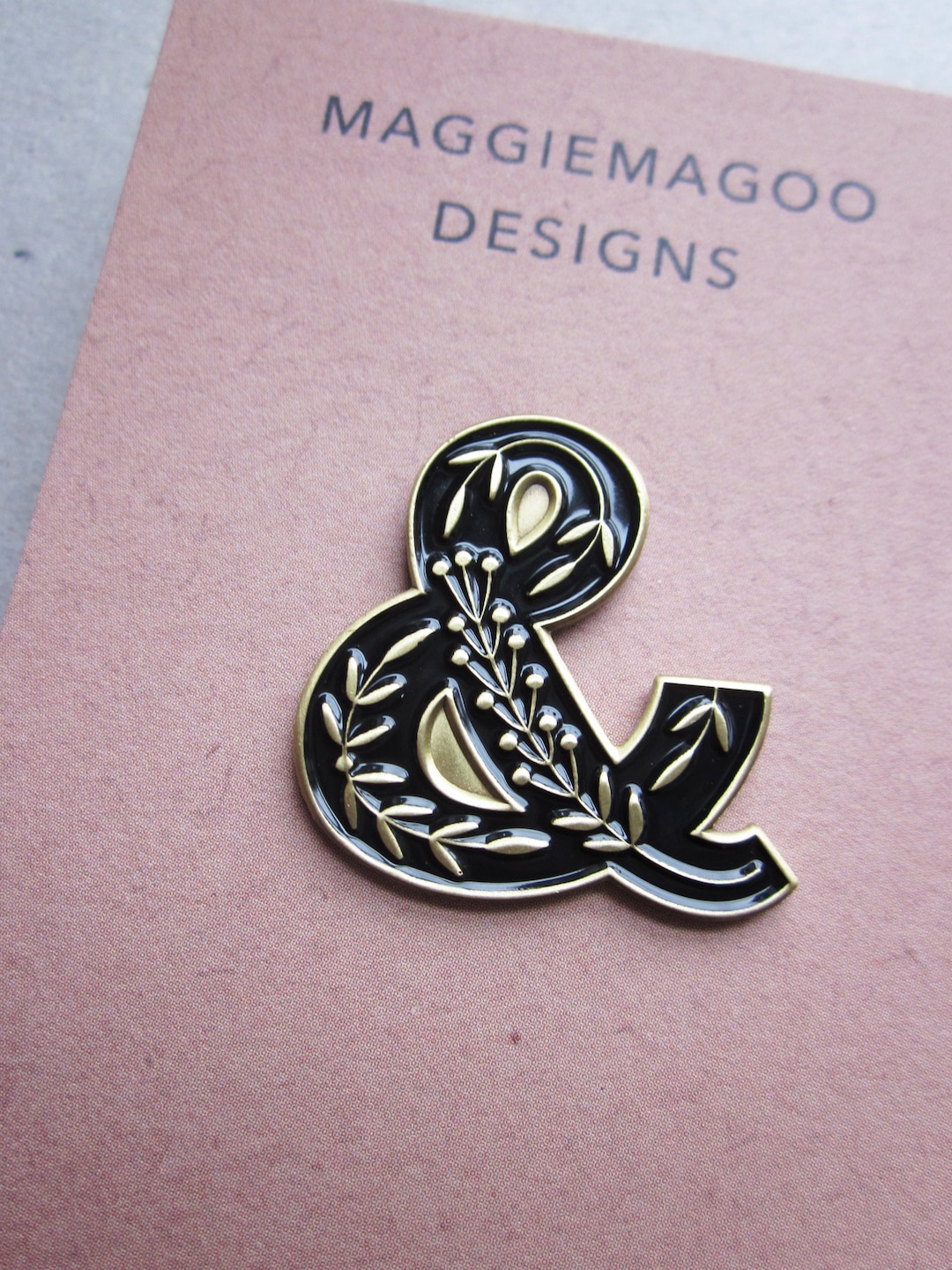 Ampersand enamel pin brooch, folk art design, black and gold metal, typography design