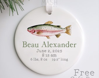May include: A white ceramic ornament featuring a watercolor illustration of a fish. The ornament includes the name "Beau Alexander", birthdate, time, weight (6 lbs, 8 oz), and length (19.5 inches). A white ribbon is attached for hanging.