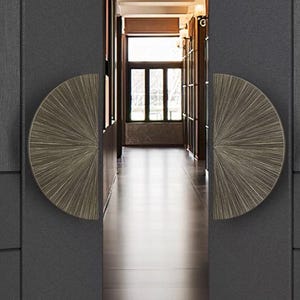 May include: Two half-circle door pulls with a brushed metal finish. The pulls are mounted on a dark gray door.