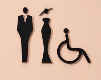Könnte beinhalten: Schwarz-weiße Toilettenzeichen mit einem männlichen, weiblichen und einem Rollstuhlsymbol.