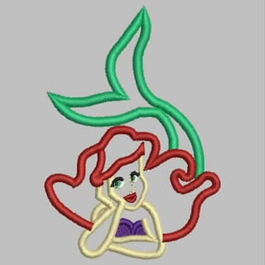 May include: An embroidered design of a mermaid with red hair, a purple top, and a green tail.