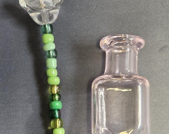 Single beaded flower in miniature glass vase. Colours and styles may vary.