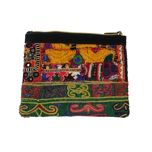 May include: A colorful patchwork fabric zippered pouch with a black zipper and a black fabric top. The pouch is decorated with embroidered designs and small mirrors.