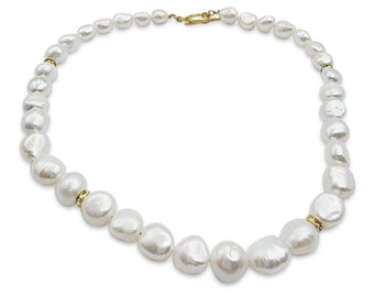 May include: A white pearl necklace with a gold clasp. The pearls are irregular in shape and size, and they are strung on a thin gold chain.