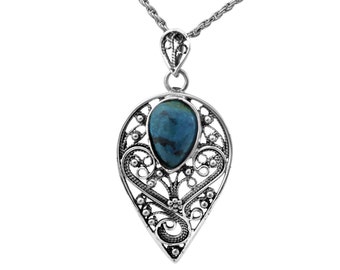 May include: A silver necklace with a teardrop-shaped pendant featuring a blue gemstone set in a filigree design.