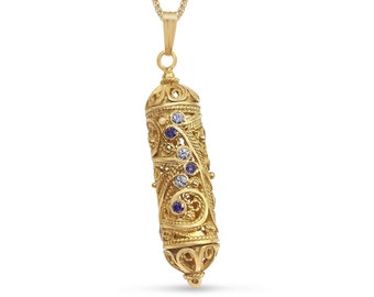 May include: A gold necklace with a detailed pendant shaped like a Torah scroll. The pendant is adorned with purple and white gemstones.