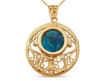 May include: A gold necklace with a round pendant featuring a blue gemstone surrounded by intricate filigree details.