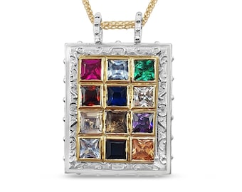 May include: A silver and gold pendant necklace with a square-shaped charm featuring a grid of 12 colorful gemstones. The charm has a decorative border and is suspended from a gold chain.